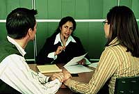 A couple holding hands meeting with a mitigation specialist