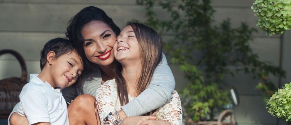 Mother hugging 2 children